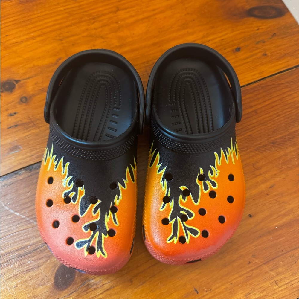 CROCS Black and Orange Slippers with Artistic Design